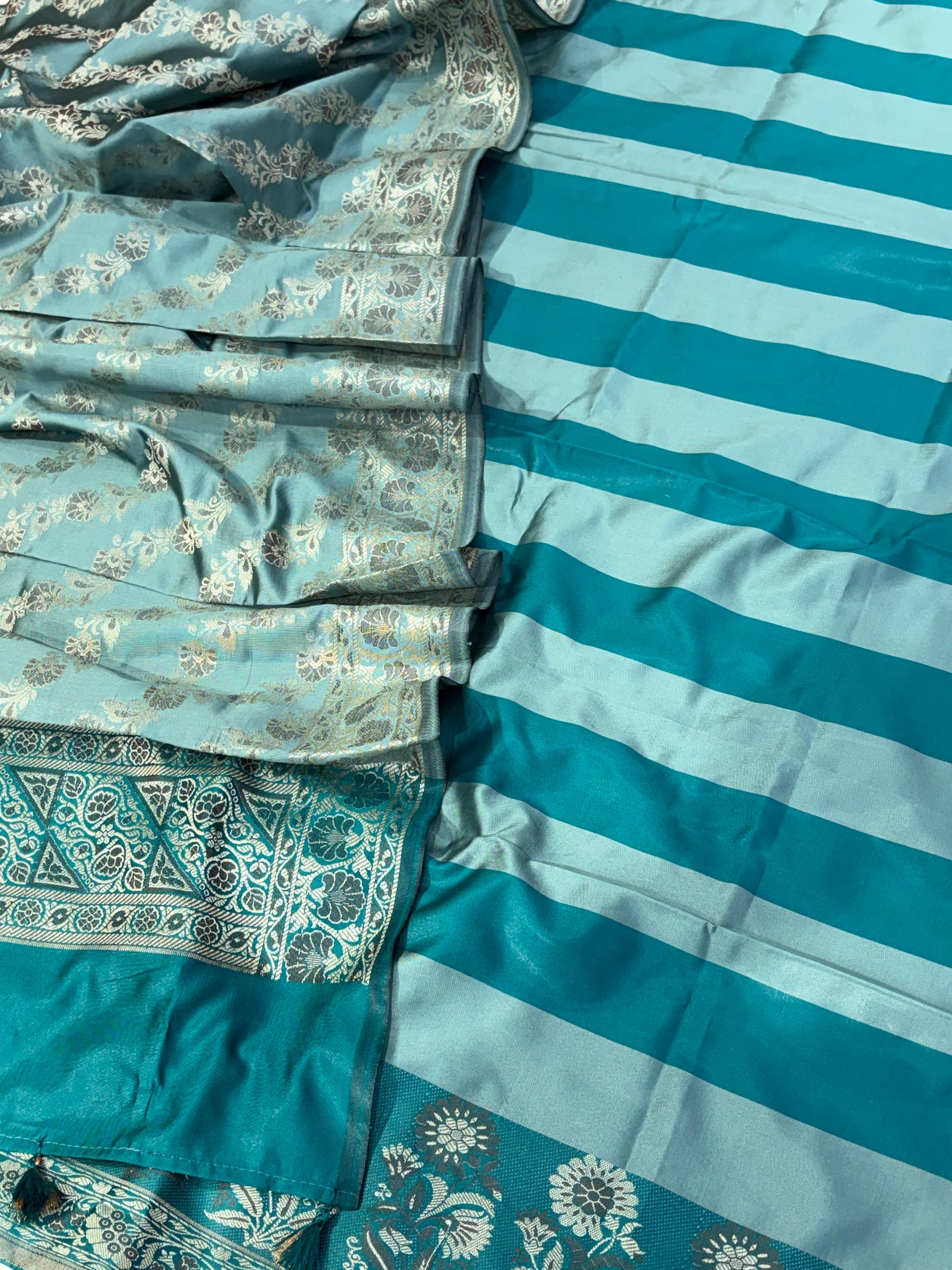 Banarasi soft silk suit in teal blue  with ice blue colour combination with tussels
