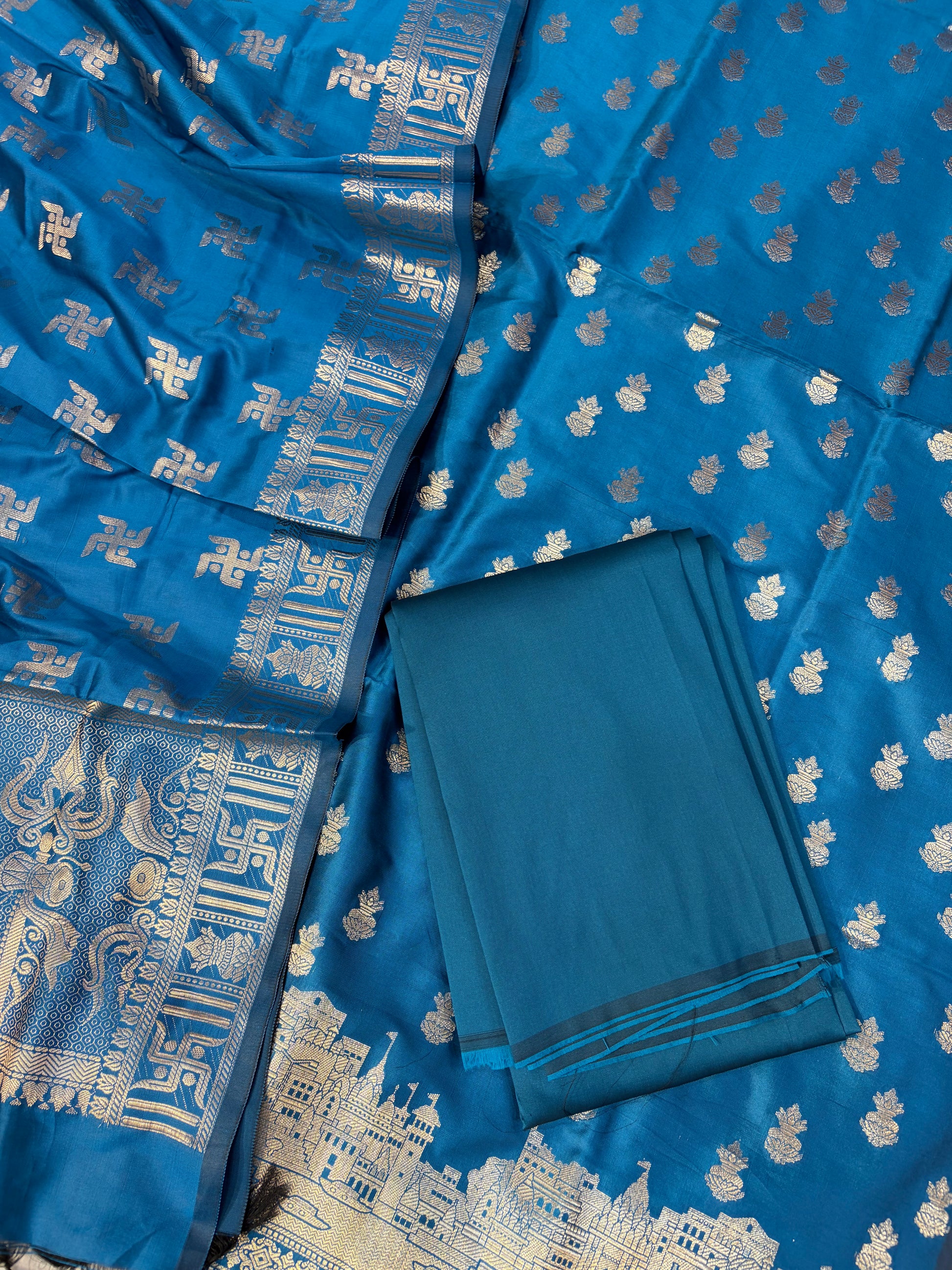 Banarasi soft silk suit in Teal blue colour with temple design work