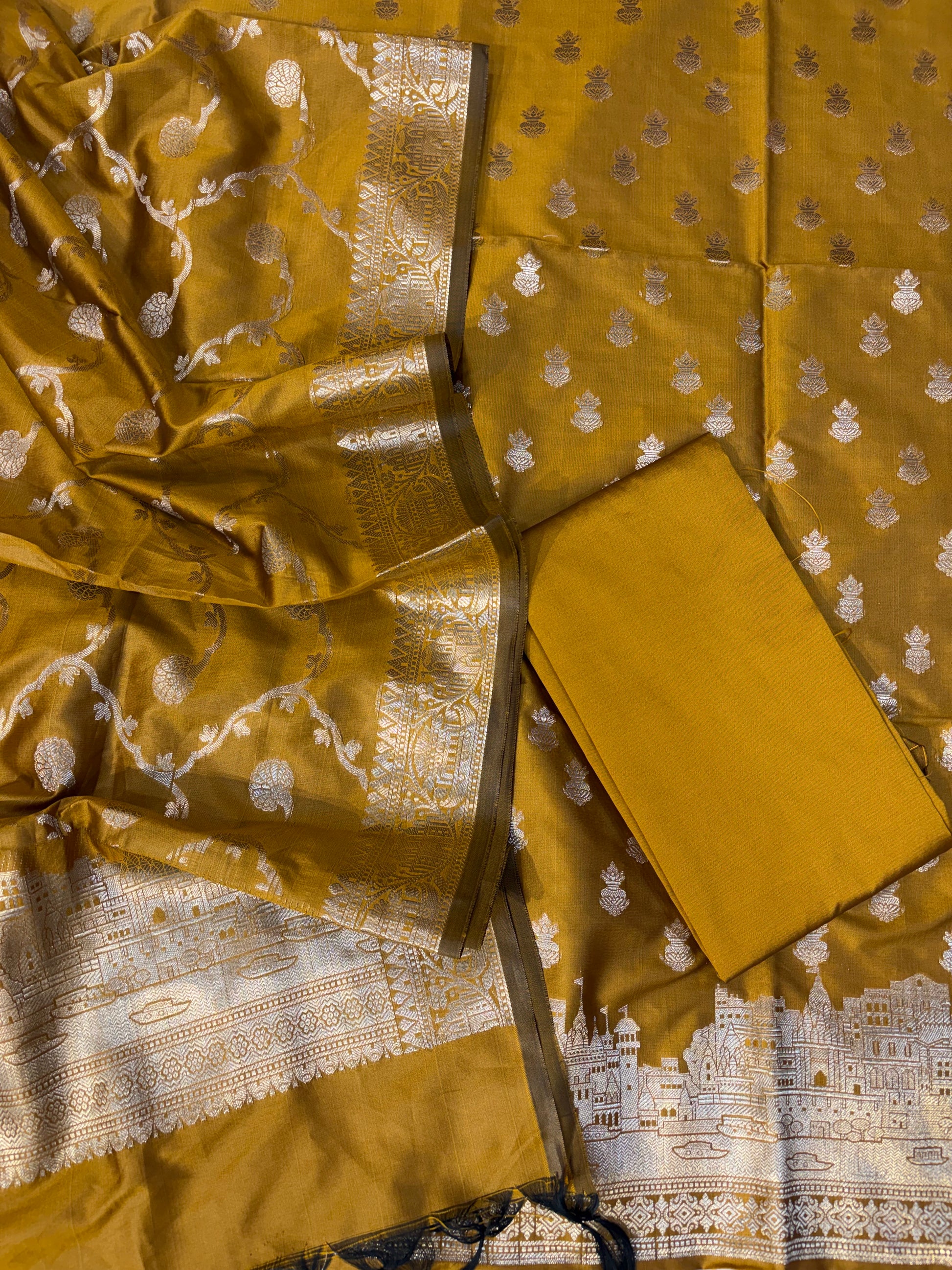 Banarasi soft silk suit in gold colour with temple design work