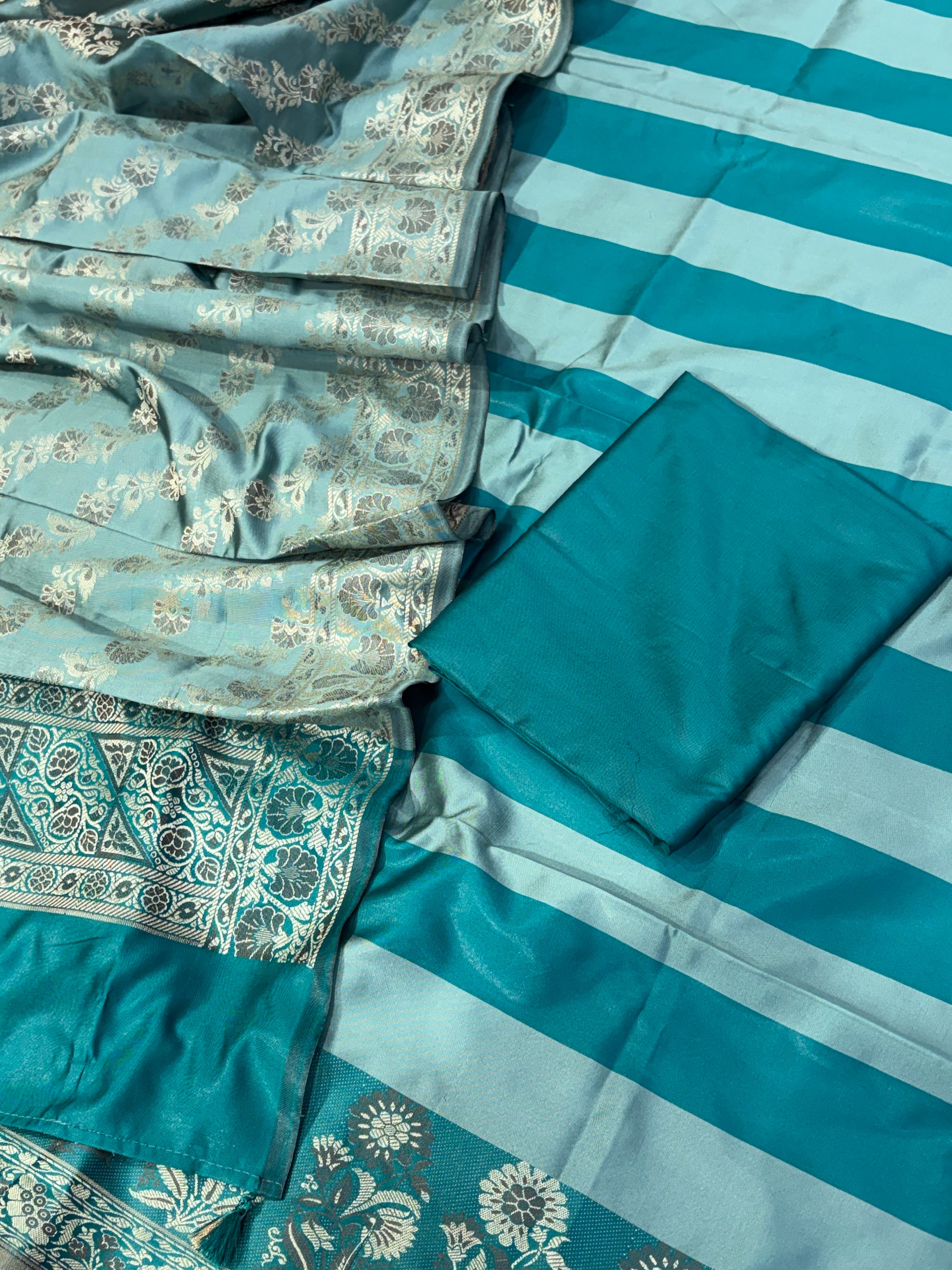 Banarasi soft silk suit in teal blue  with ice blue colour combination with tussels