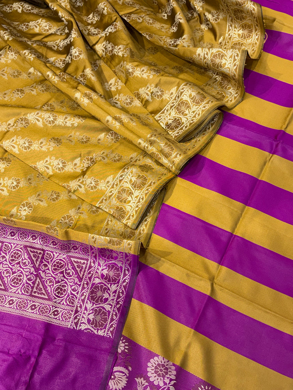 Banarasi soft silk suit in mustard yellow with magenta pink colour combination with tussels