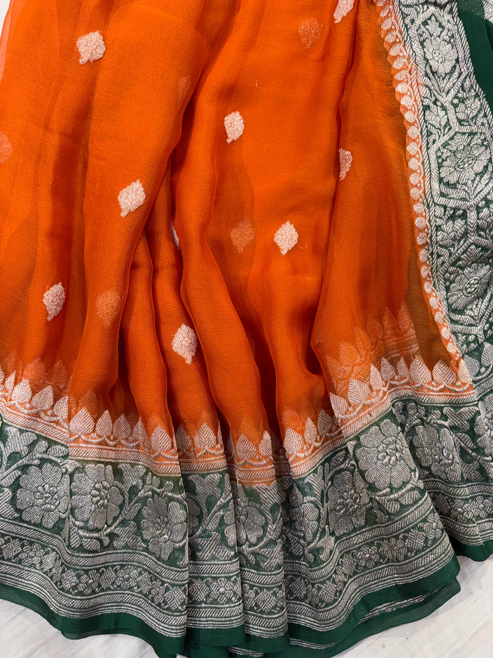 Pure khaddi chiffon saree in rust orange with bottle green colour