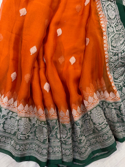 Pure khaddi chiffon saree in rust orange with bottle green colour