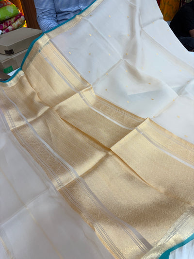 Pure handloom organza silk saree In off white colour with Rama green piping border