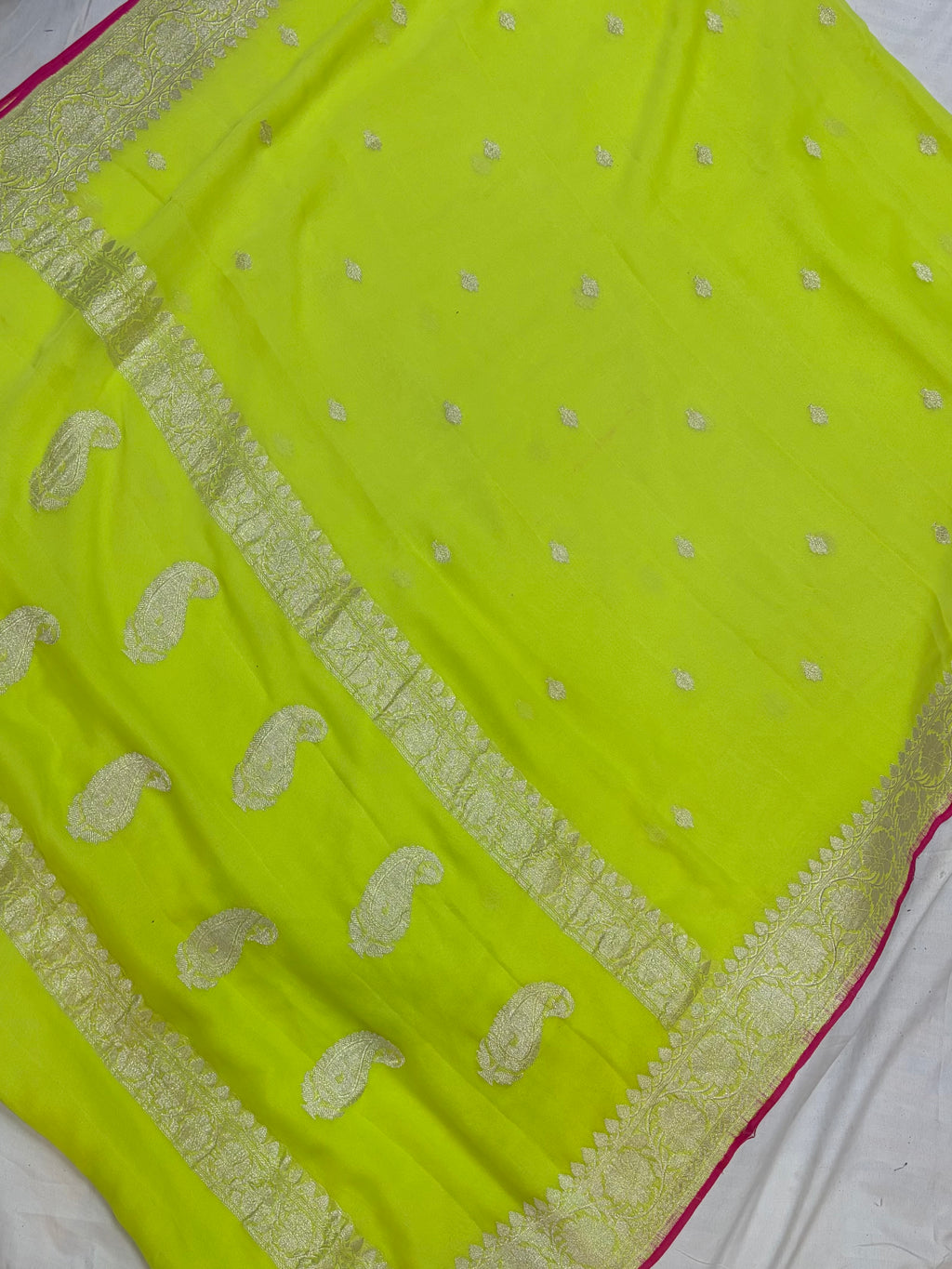 Pure khaddi chiffon saree in neon green colour with Rani pink piping border