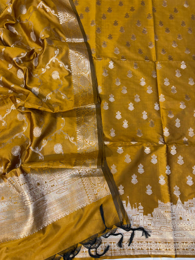 Banarasi soft silk suit in gold colour with temple design work