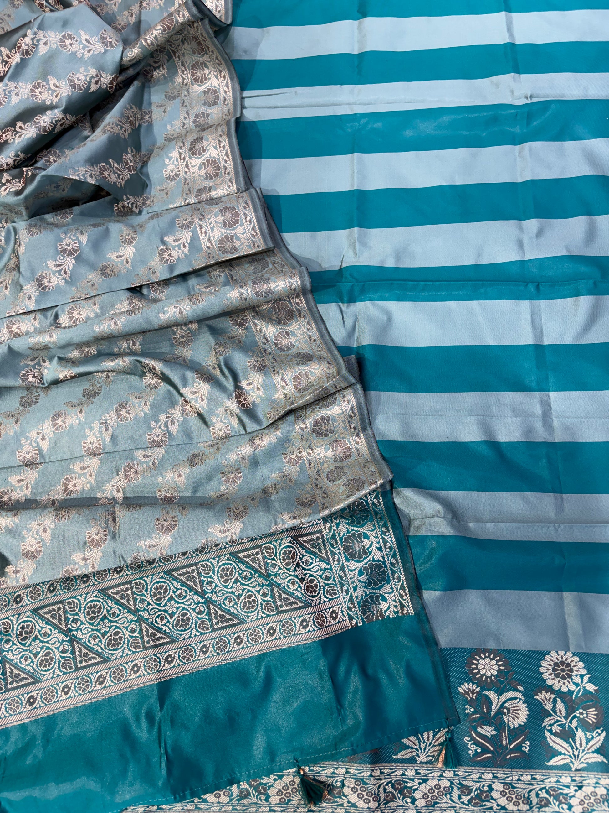 Banarasi soft silk suit in teal blue  with ice blue colour combination with tussels