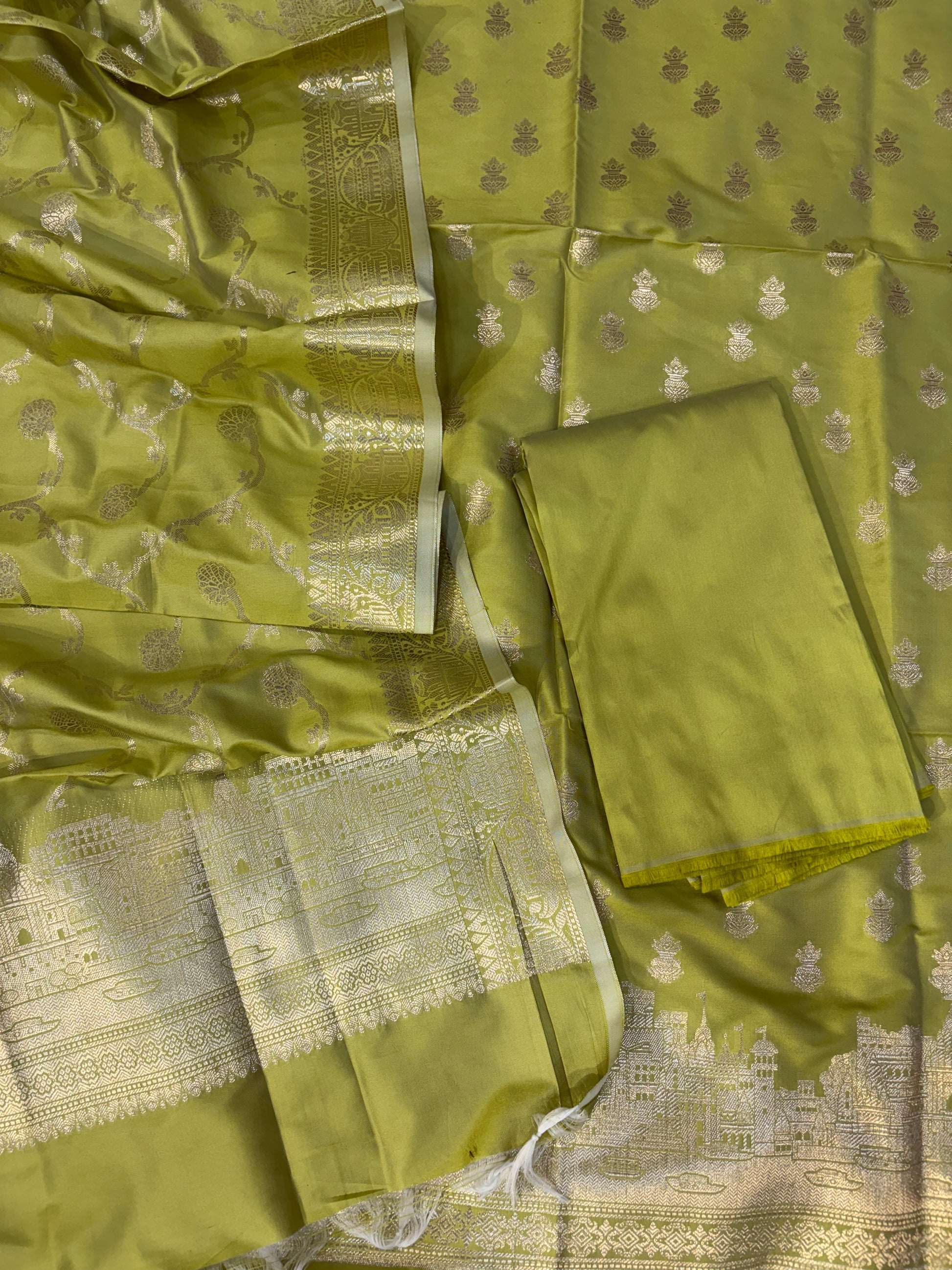 Banarasi soft silk suit in Lime green colour with temple design work