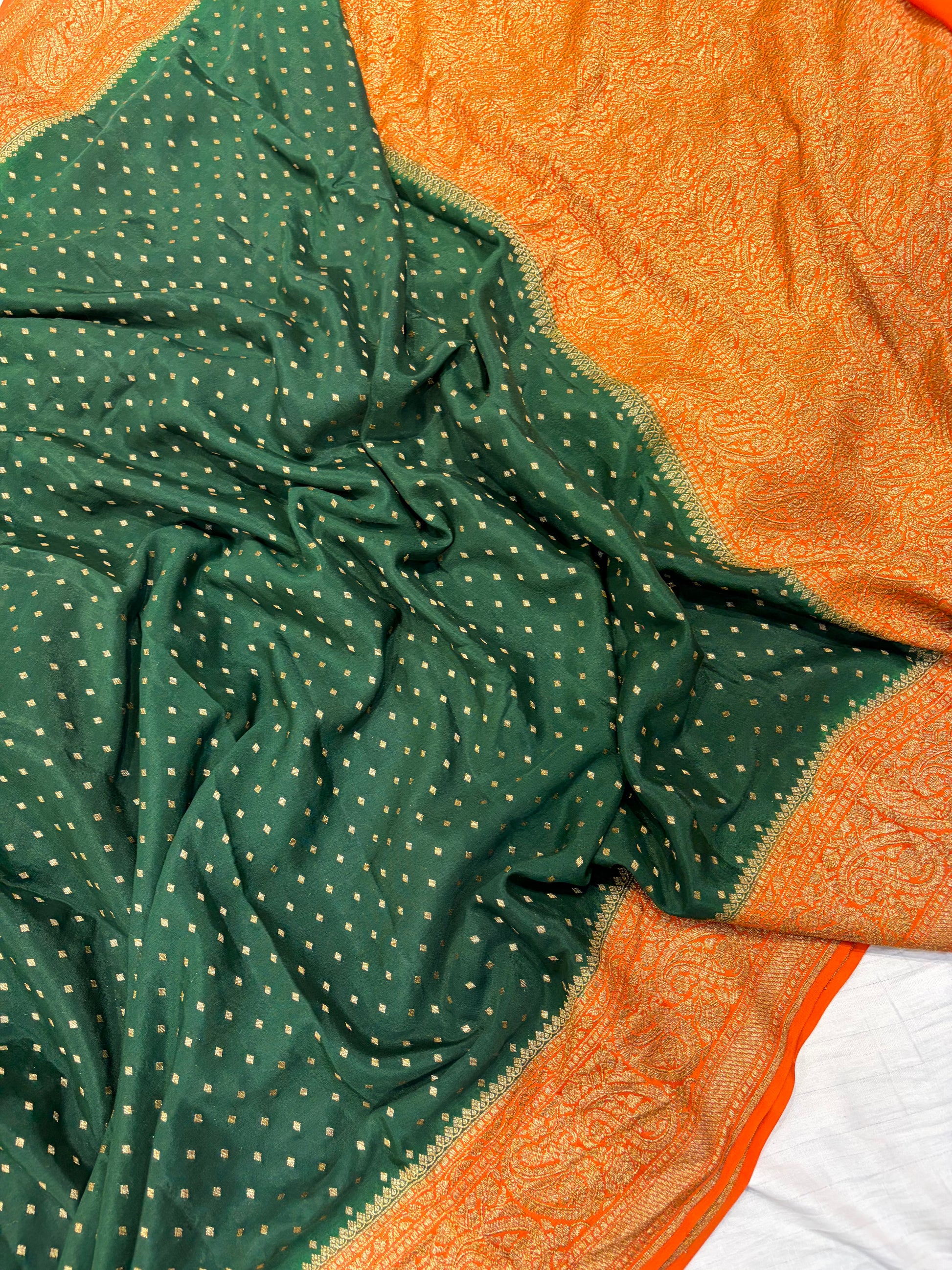 Pure khaddi crepe silk saree in bottle green bright orange colour