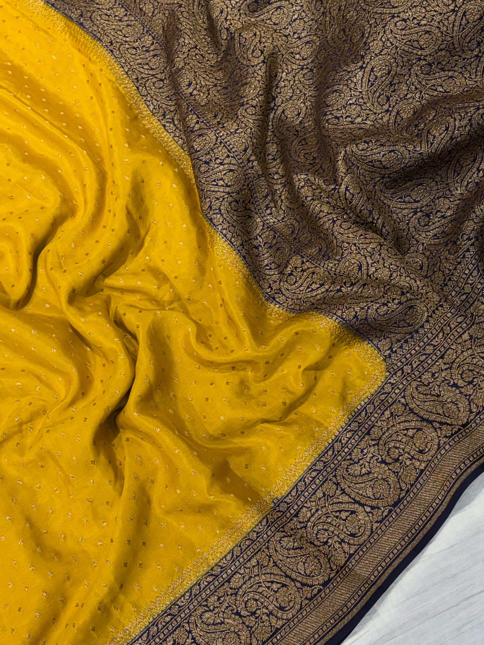 Pure khaddi crepe silk saree in mustard yellow with dark navy blue colour