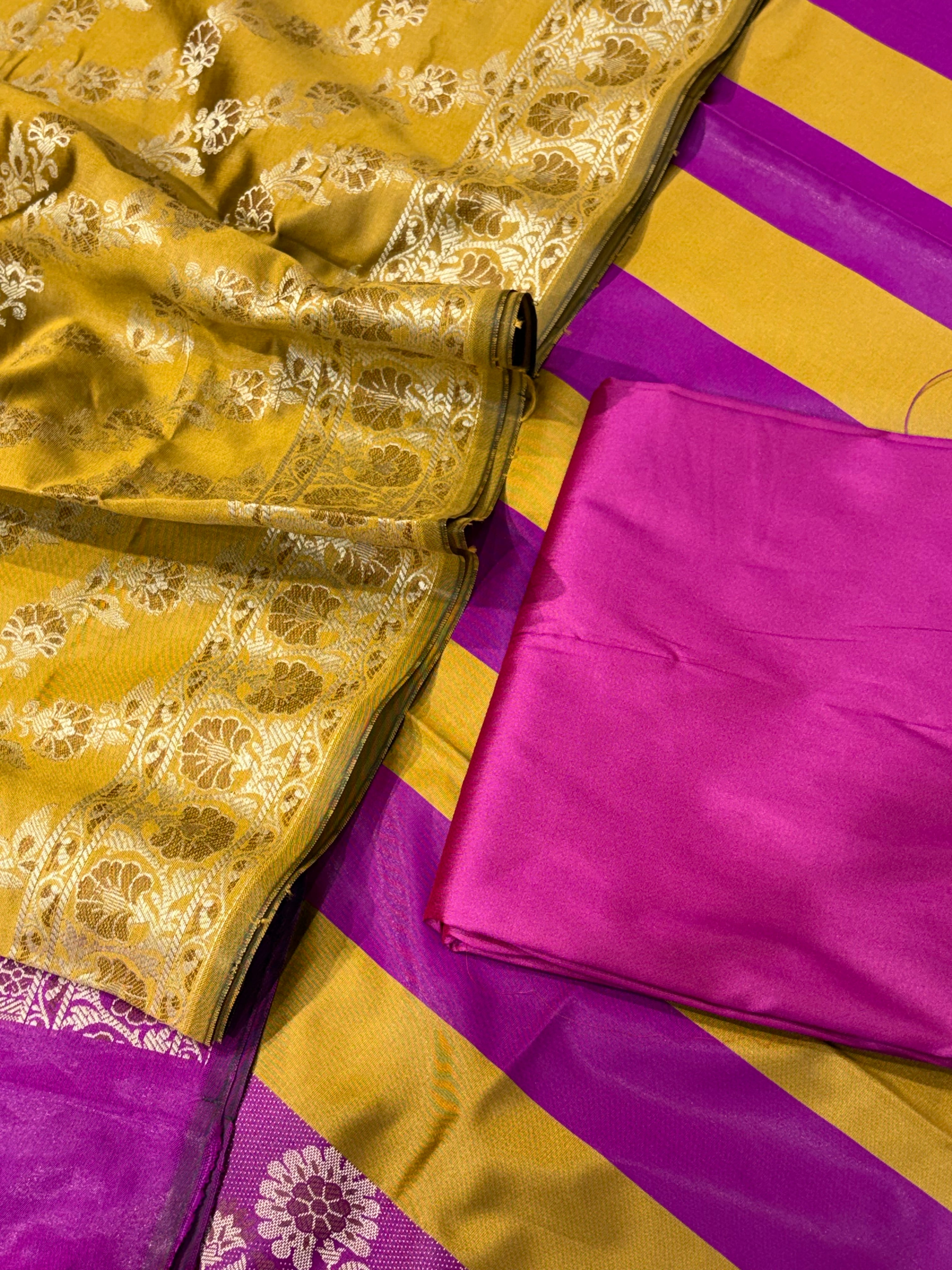 Banarasi soft silk suit in mustard yellow with magenta pink colour combination with tussels