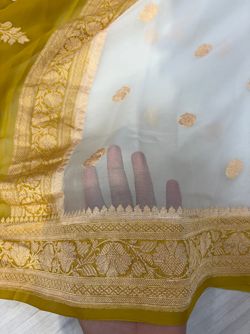 Pure khaddi chiffon saree with gold zari work in off white with olive yellow colour