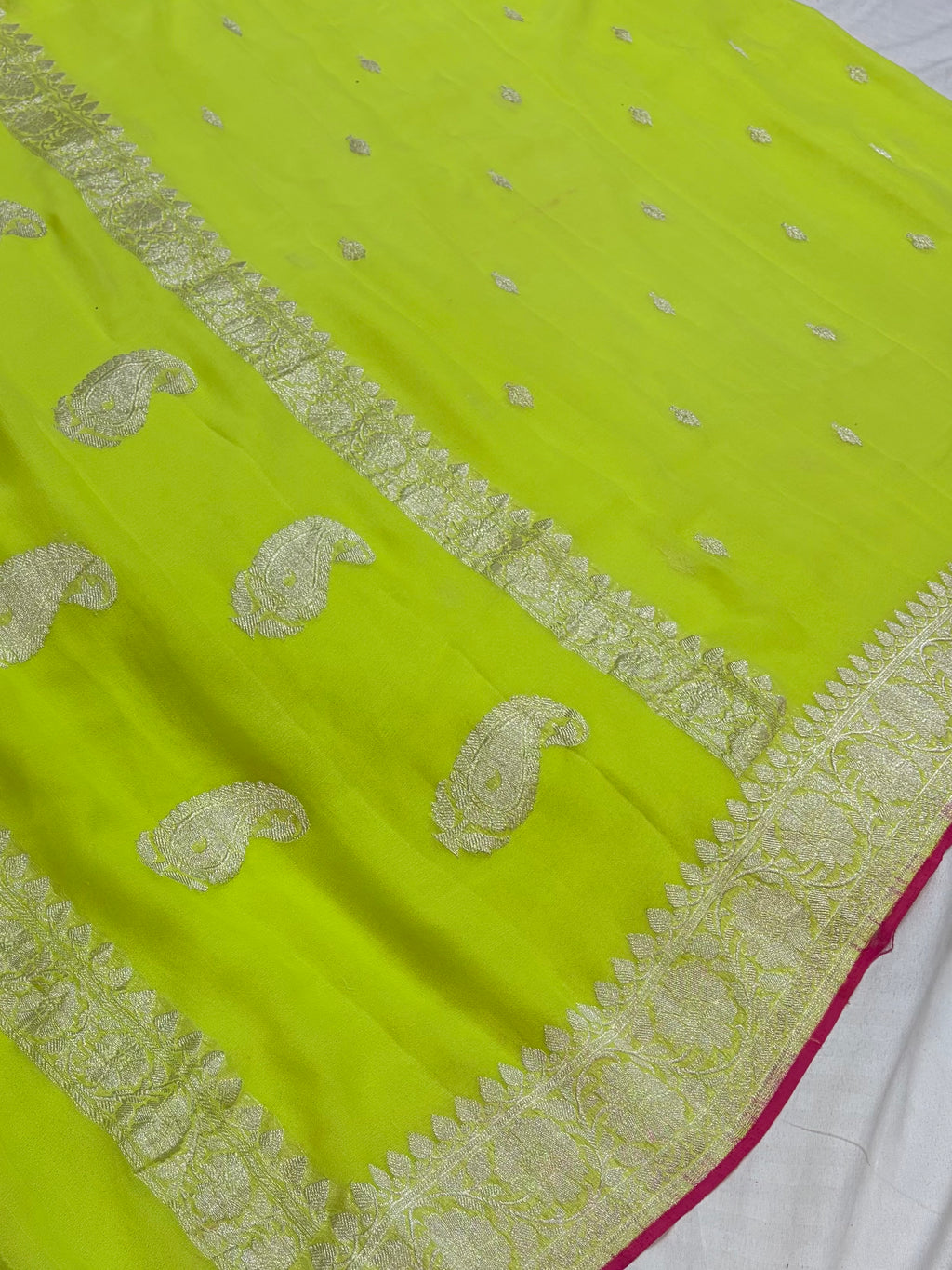 Pure khaddi chiffon saree in neon green colour with Rani pink piping border