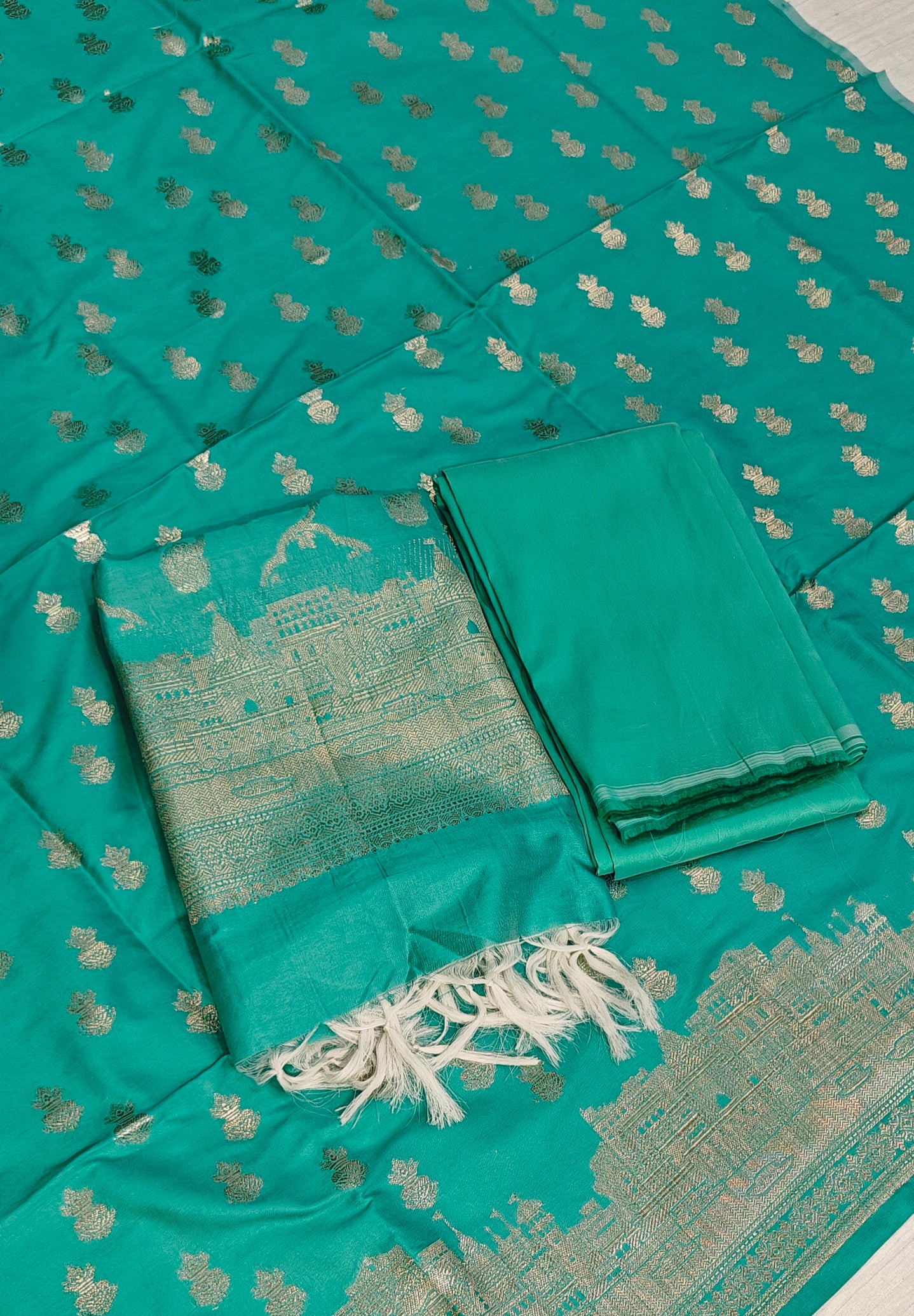 Banarasi soft silk suit in rama colour with temple design work