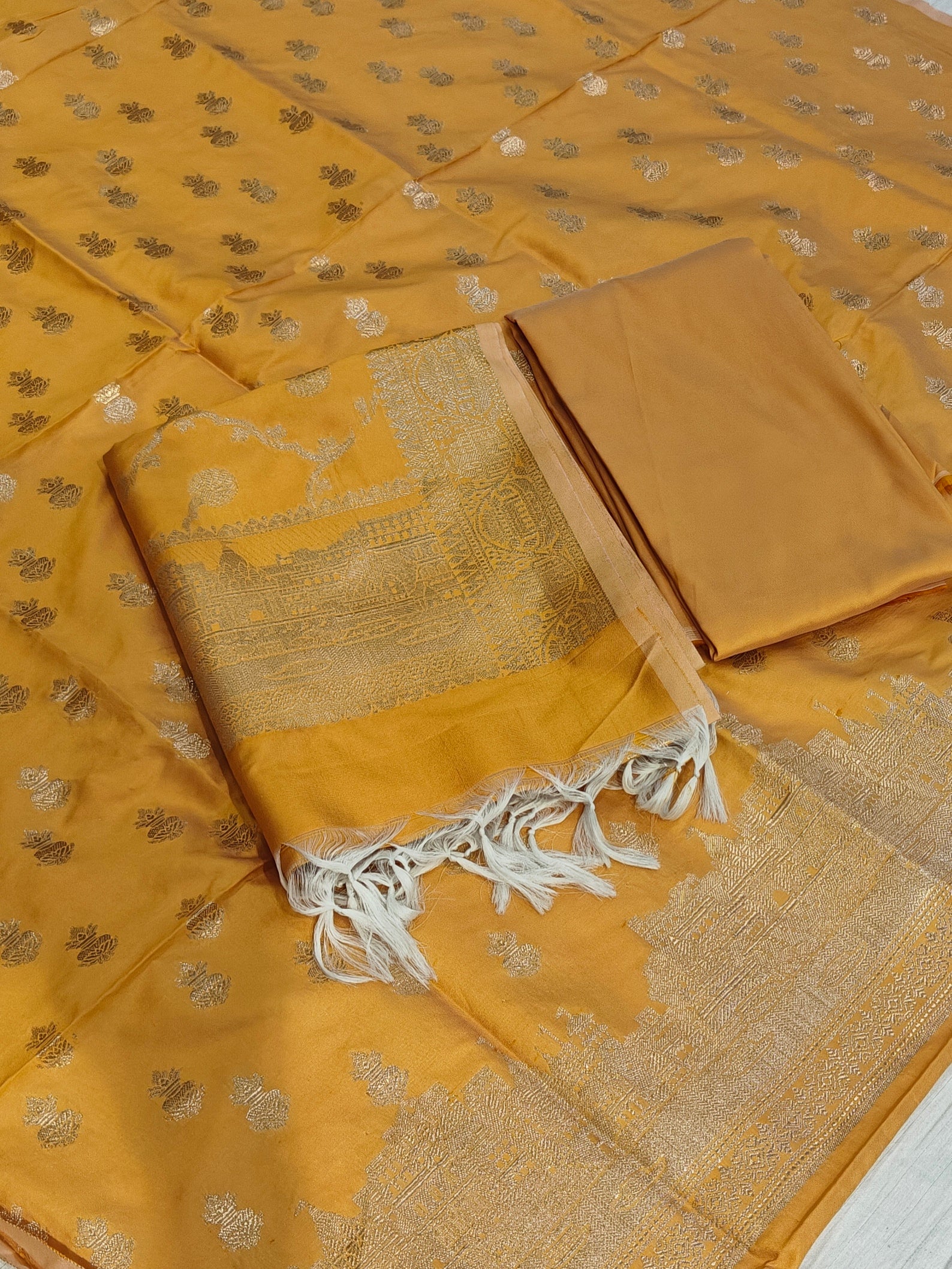 Banarasi soft silk suit in yellow colour with temple design work