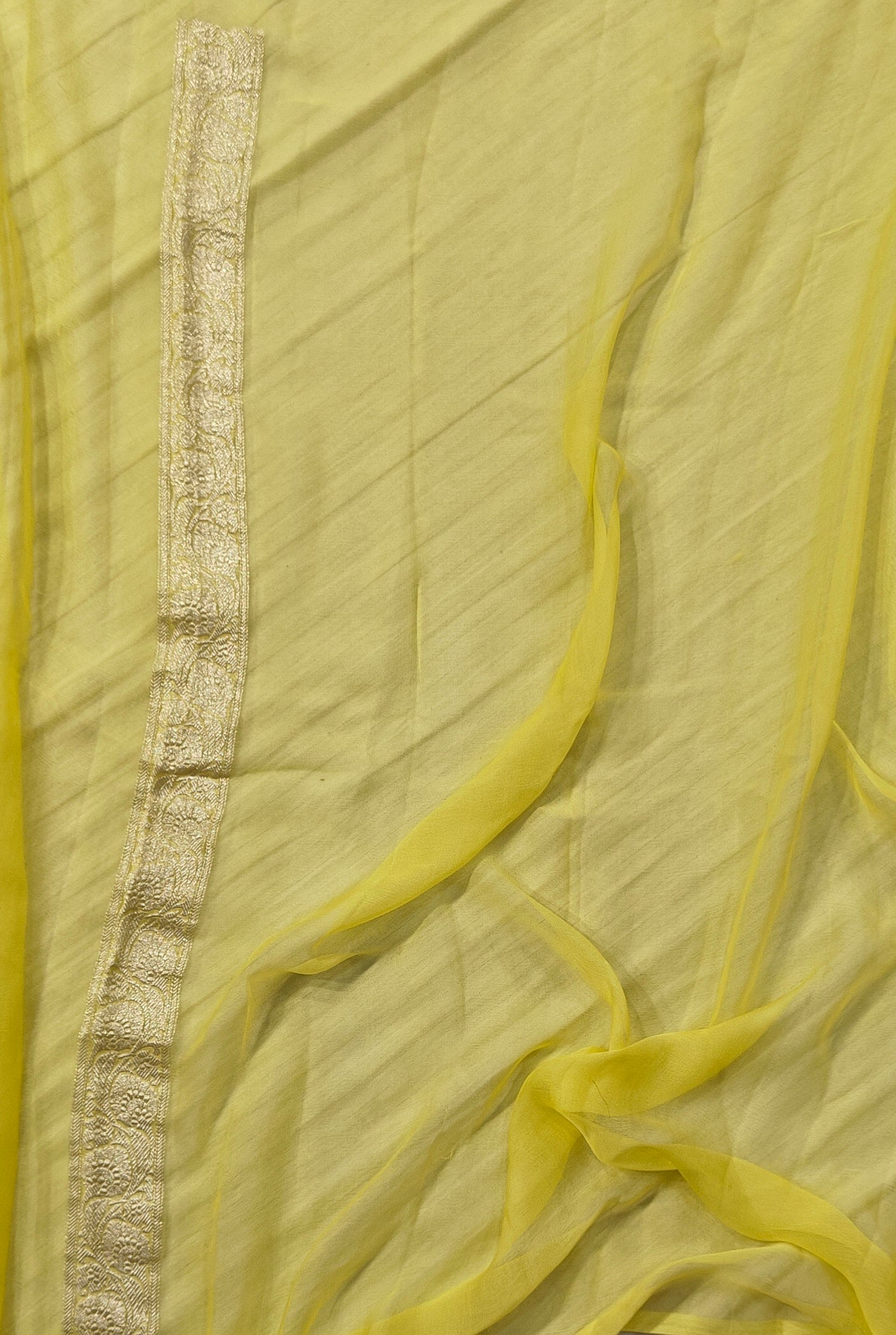 Pure khaddi chiffon saree in lemon yellow colour with all over chickenkari work