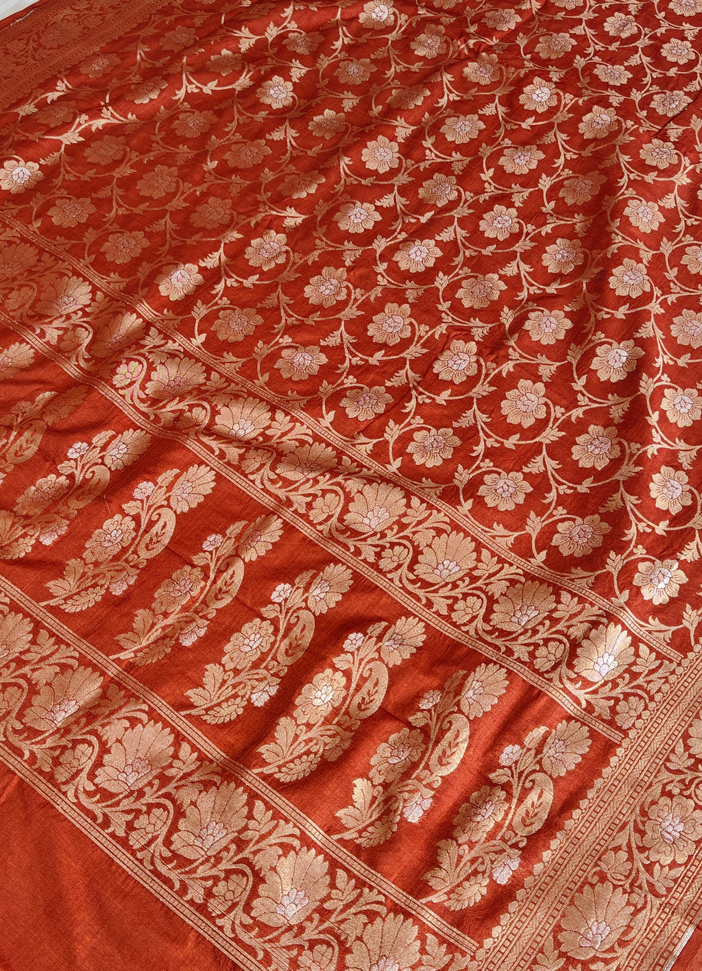 Banarasi georgette silk saree in rust orange colour with sonarupa detailing