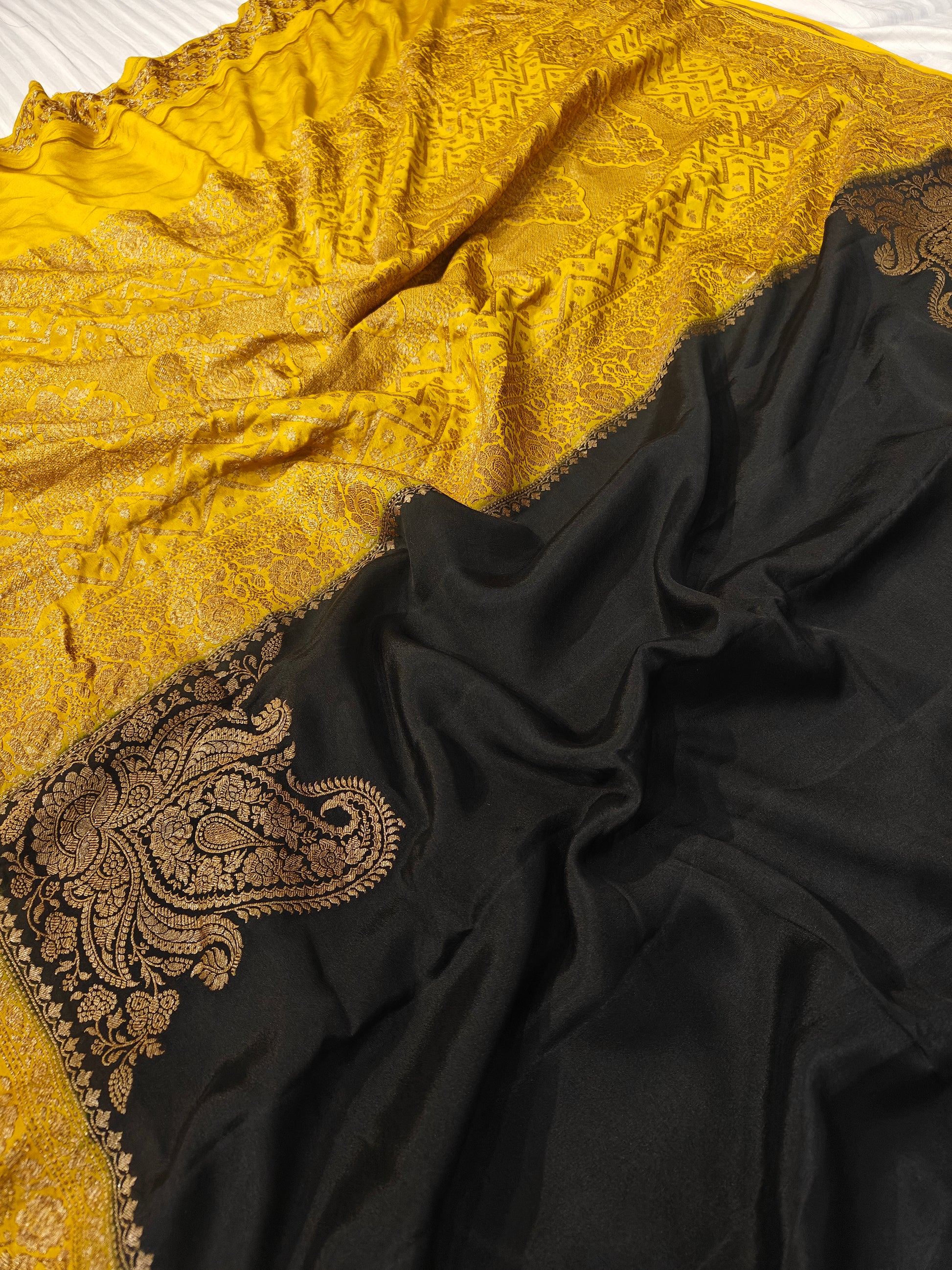 Pure khaddi crepe silk saree in black and mustard colour combination with pure antic zari work