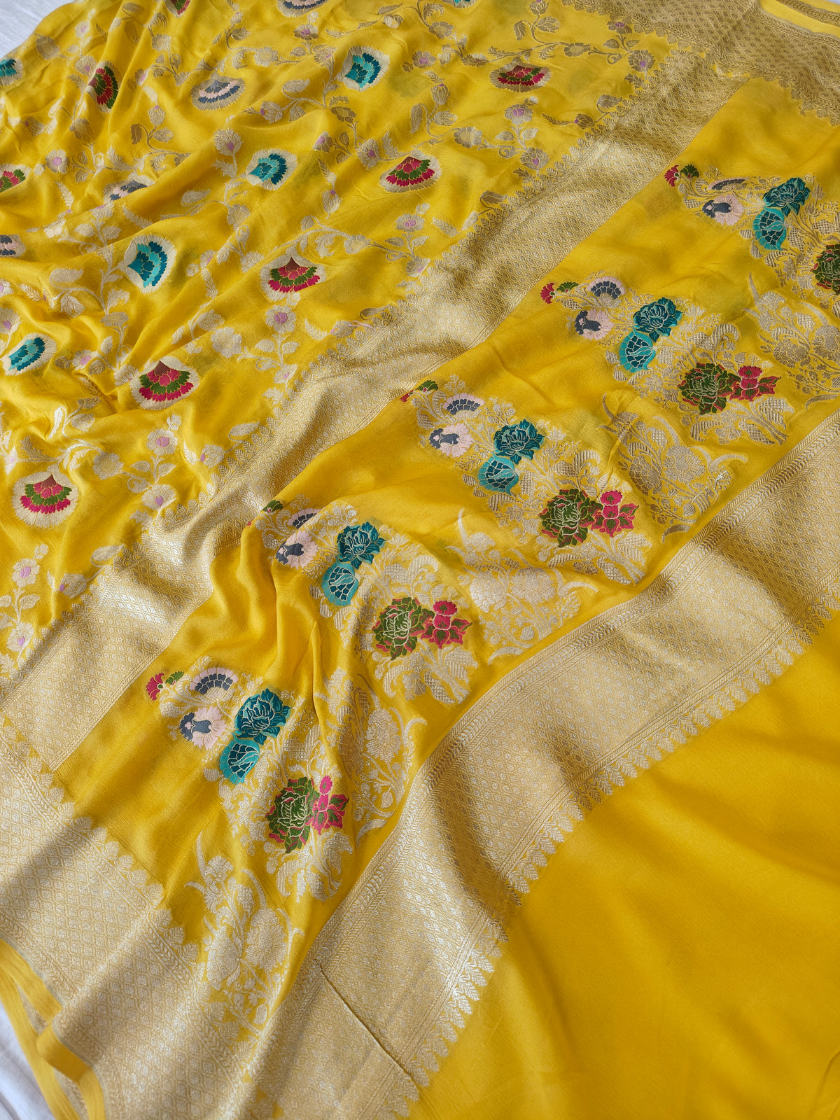 Premium pure georgette banarasi saree in yellow colour with multiple meenakari work
