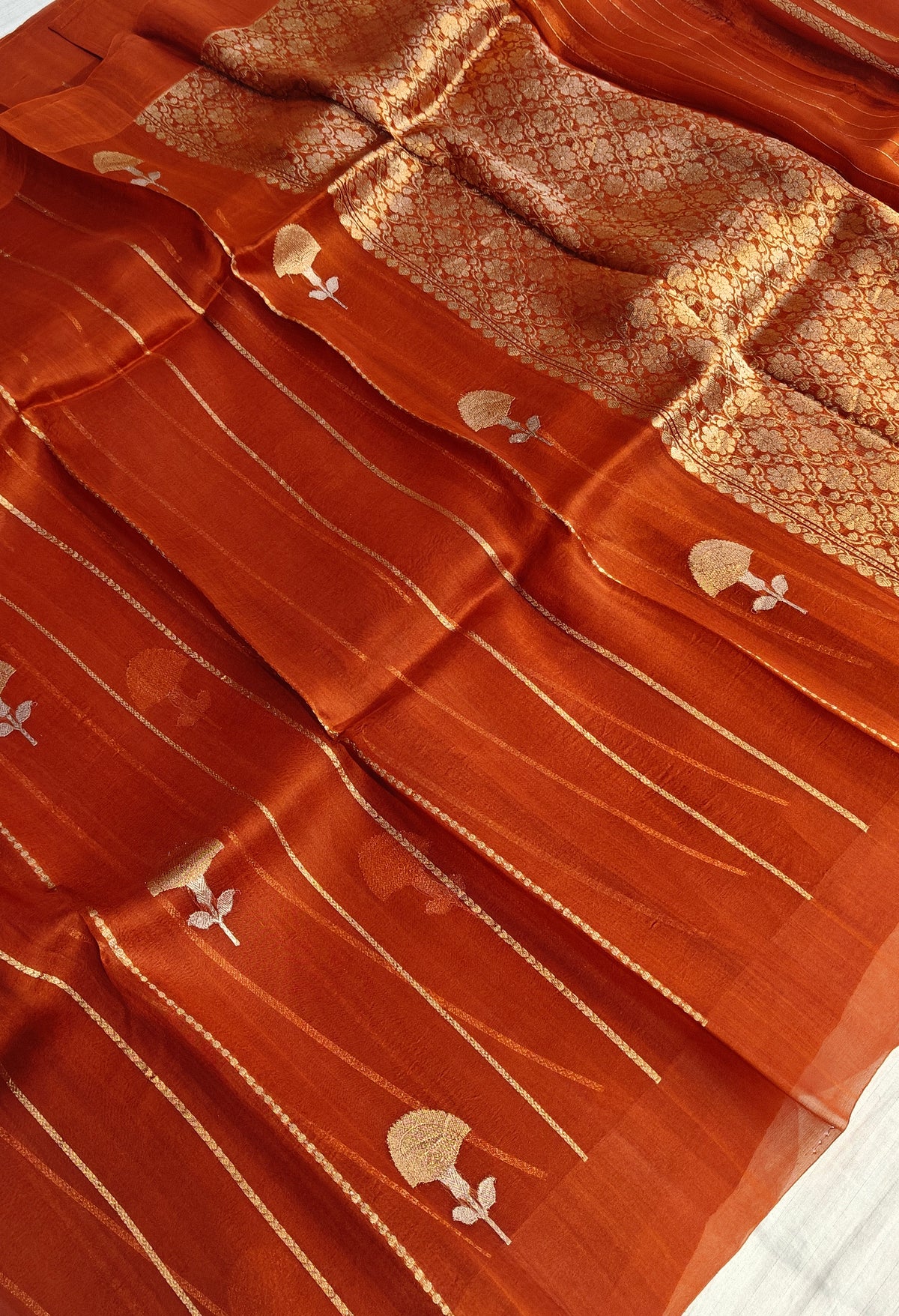 Pure handloom kora silk saree in stripes design with meenakari work in rust orange colour