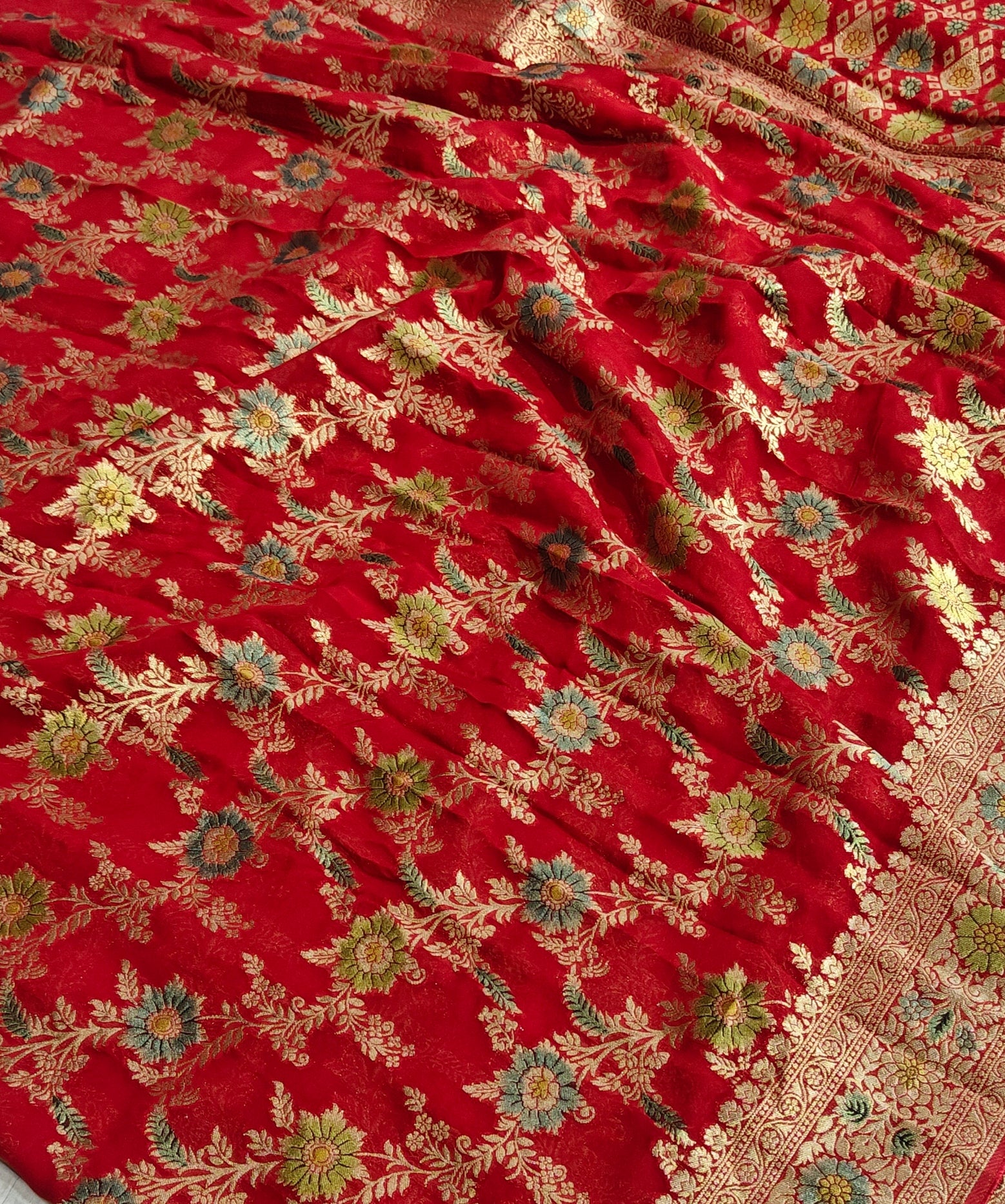 Red colour jaal georgette silk Banarasi saree with multiple meenakari work