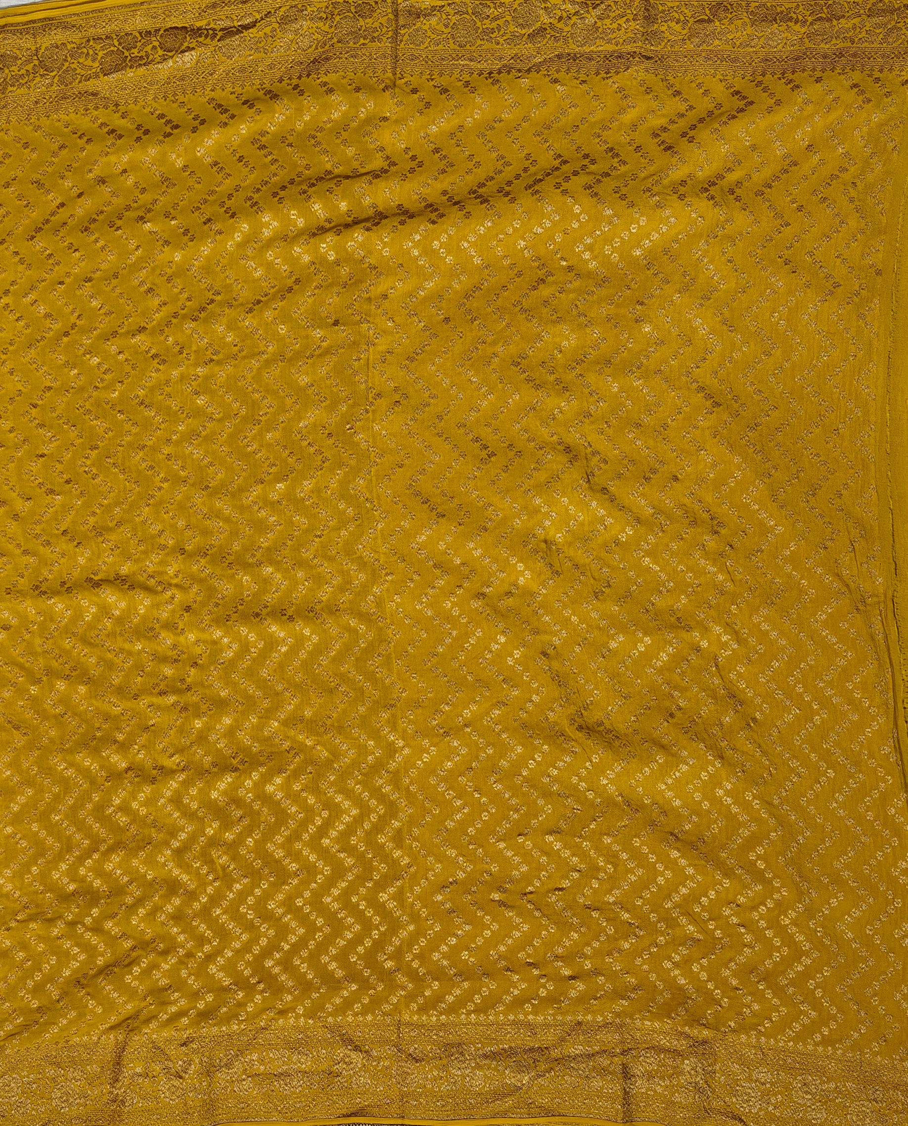 Pure khaddi crepe silk saree in black and mustard colour combination with pure antic zari work