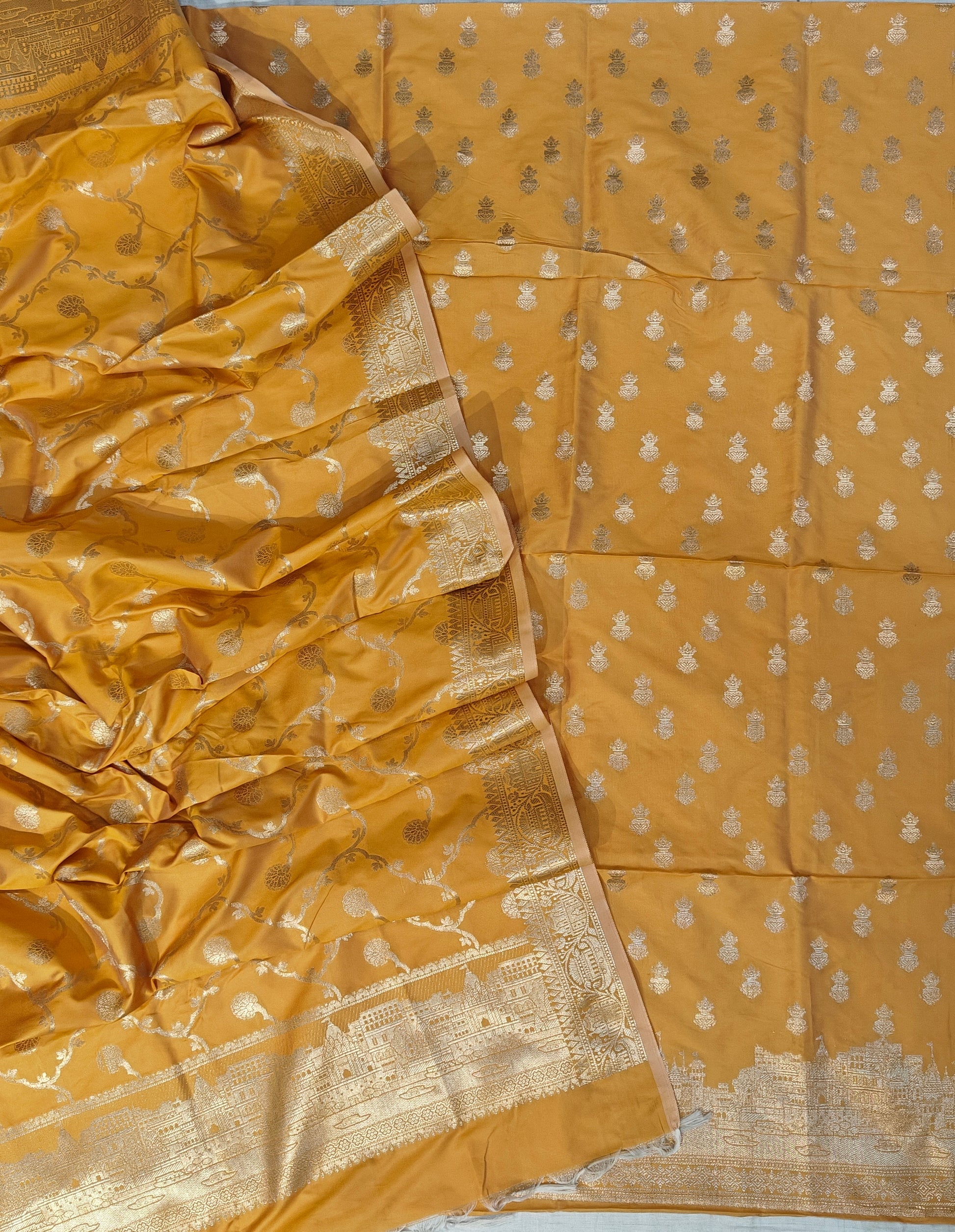 Banarasi soft silk suit in yellow colour with temple design work