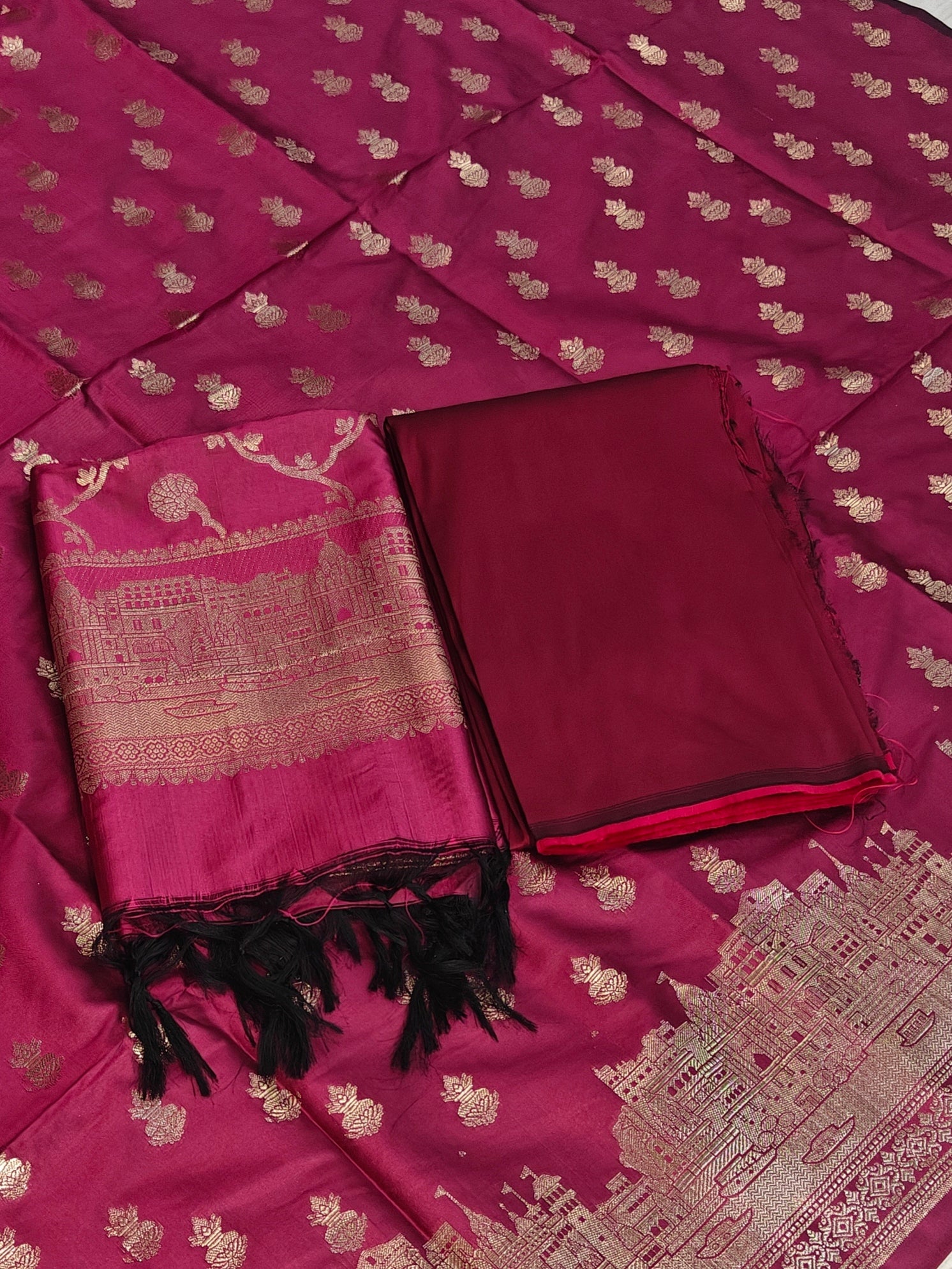 Banarasi soft silk suit in rani colour with temple design work