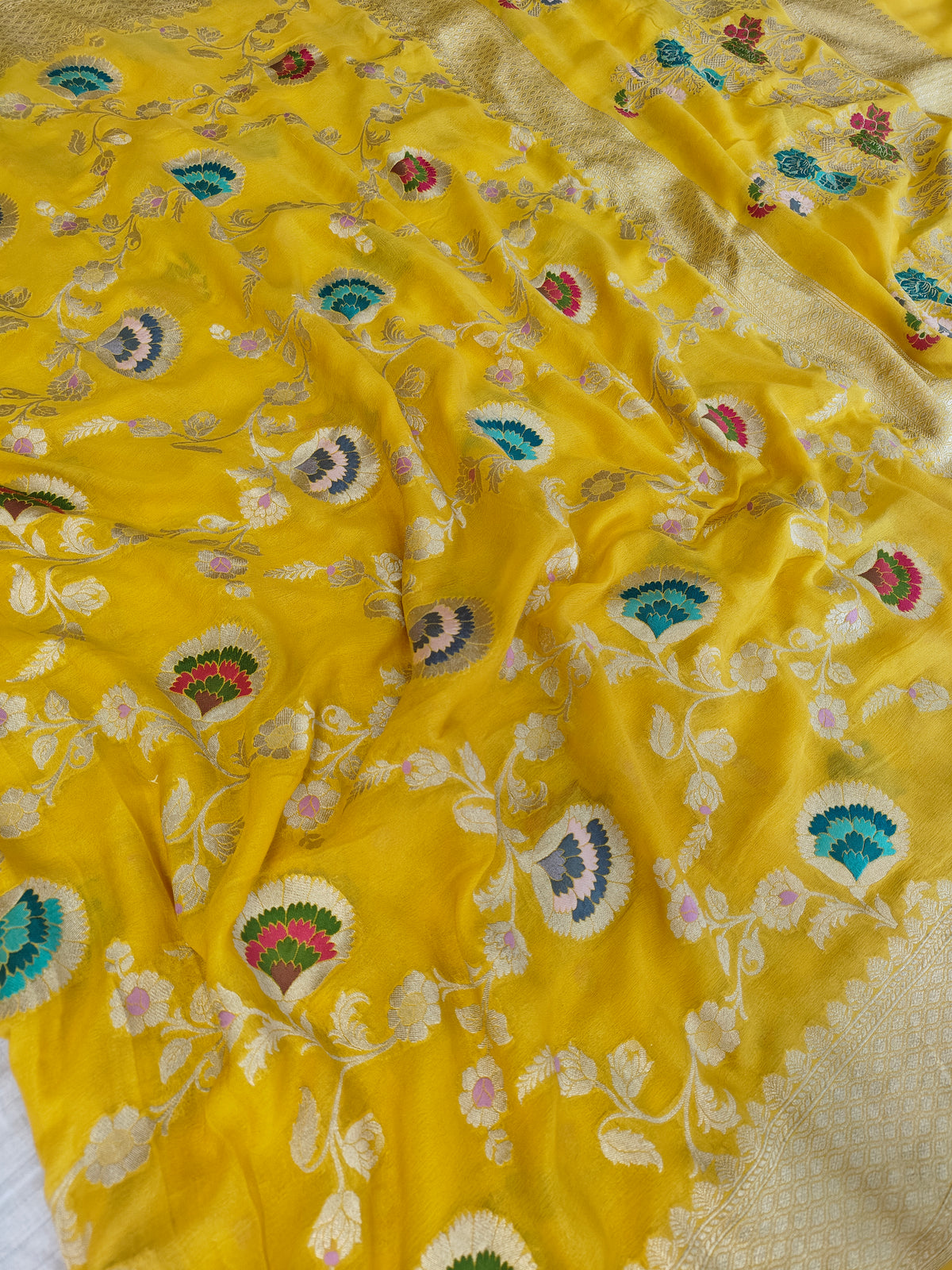 Premium pure georgette banarasi saree in yellow colour with multiple meenakari work