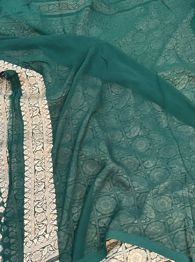 Pure georgette banarasi saree in bottle green colour with antic zari work