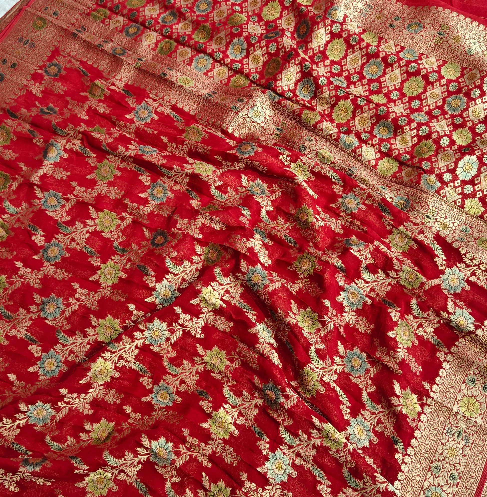 Red colour jaal georgette silk Banarasi saree with multiple meenakari work